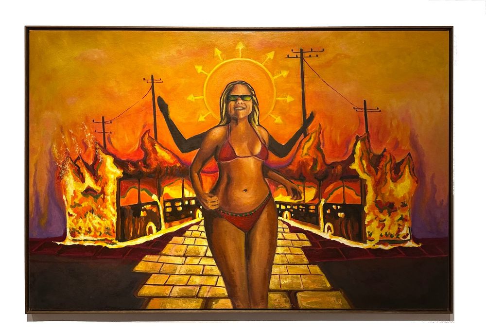 Pintura horizontal em laranja e amarelo: mulher loira de óculos escuros e biquíni vermelho, com auréola de setas, sobre uma rua de blocos dourados entre ônibus em chamas.